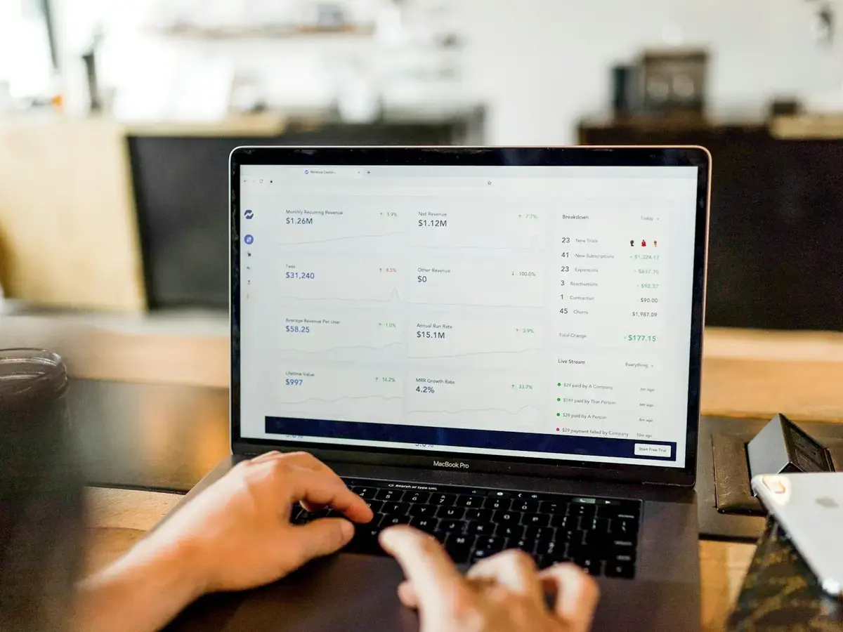 Laptop displaying a SaaS revenue dashboard with growth metrics