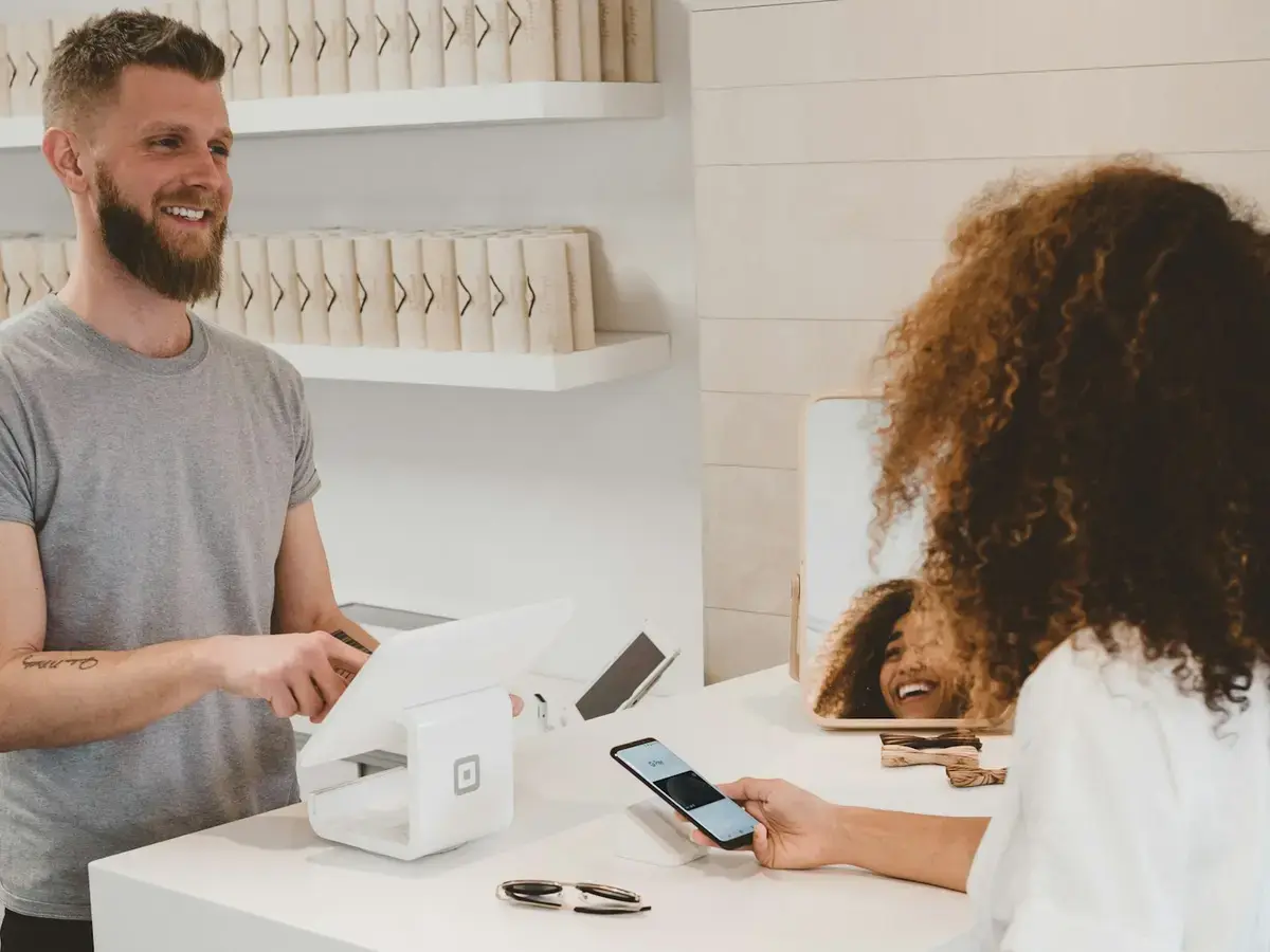 Customer paying by phone at a modern retail checkout